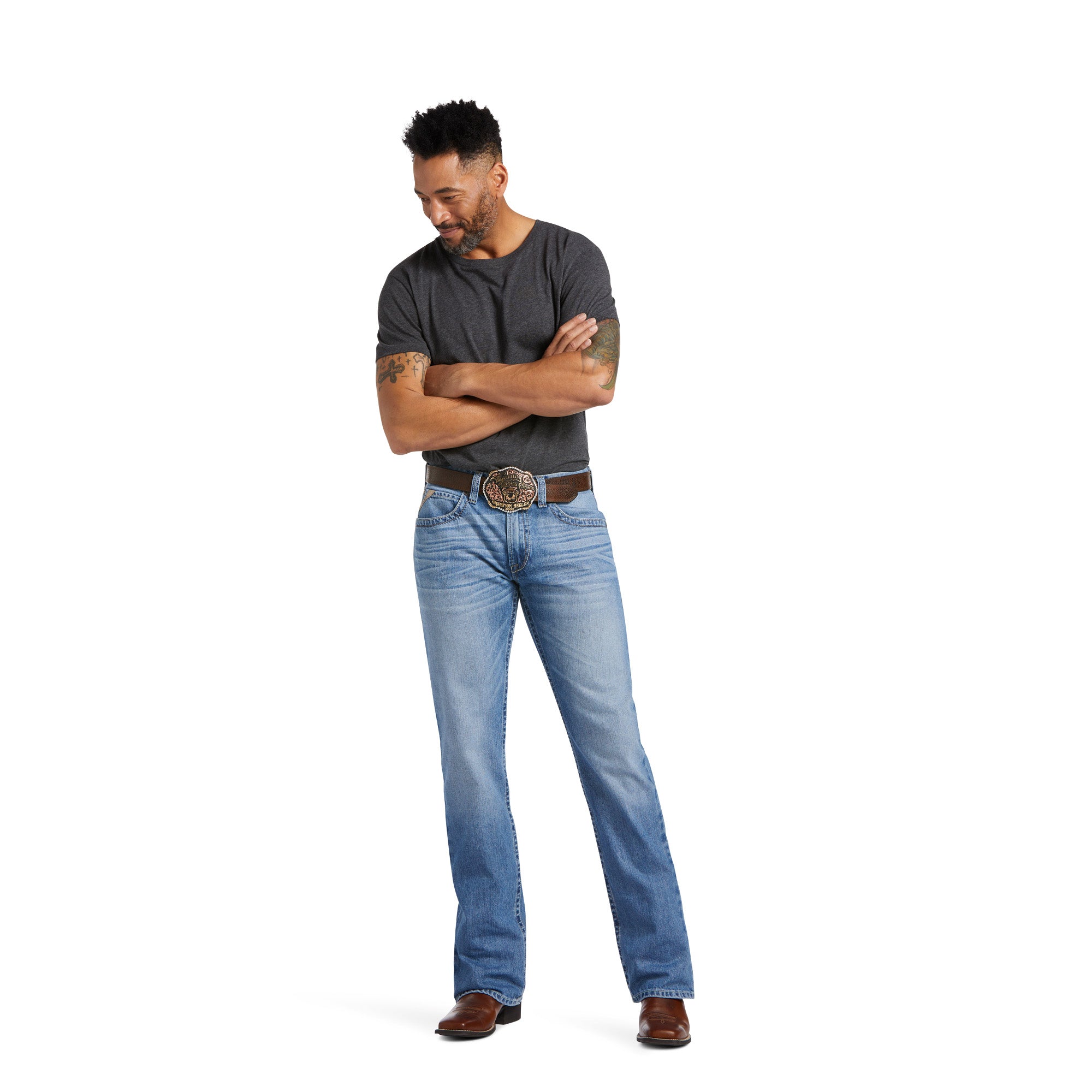 Man wearing a gray shirt and blue jeans with a belt on a white background